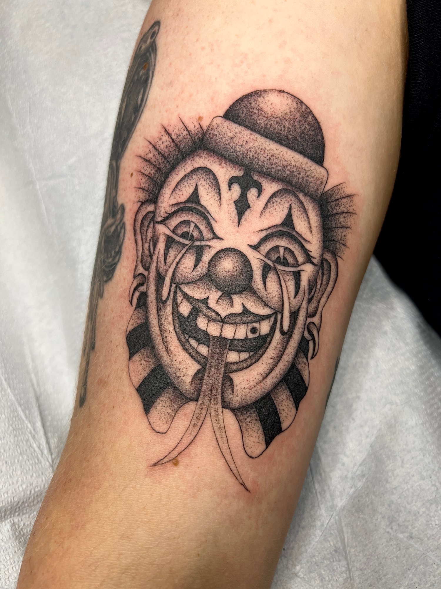 Fineline black and grey stippled tattoo of a crying clown, Portland, Oregon