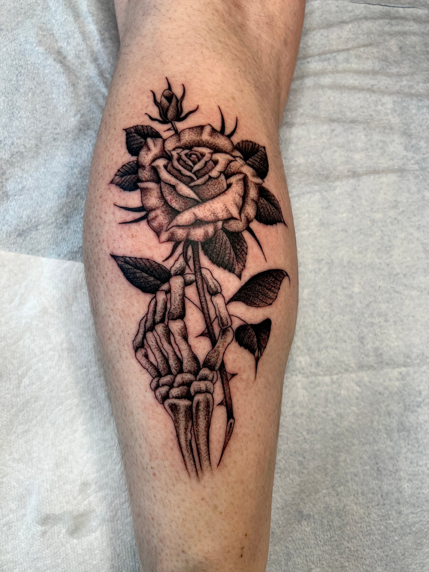 Fineline black and grey stippled tattoo of a skeleton rose, Portland, Oregon