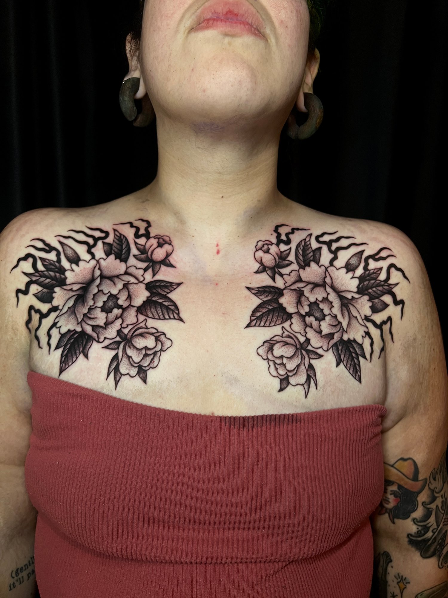 Fineline black and grey stippled tattoo of a peony chest tattoo, Portland, Oregon